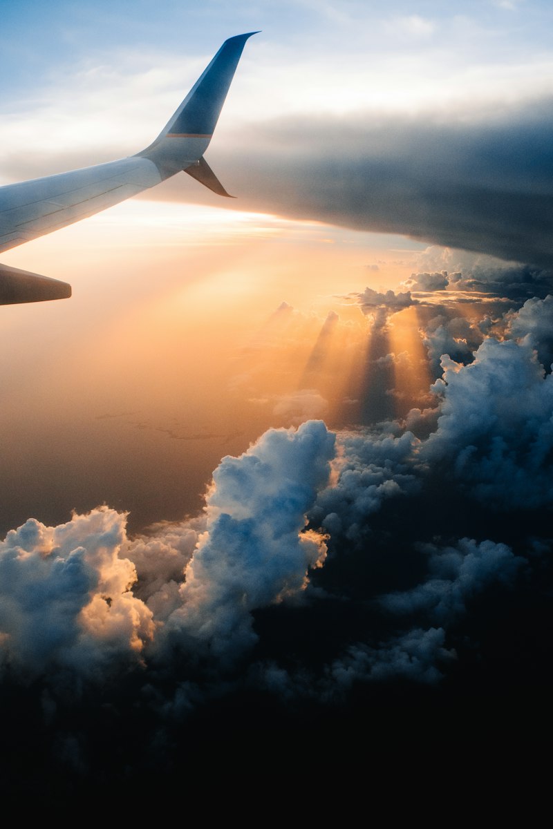 Airplane wing over clouds